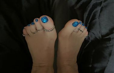 Mistress Lara plays with her perfect feet and toes in silver rings. Foot fetish